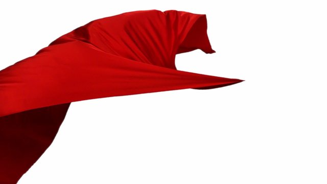 Red fabric flowing in the air on white background shooting with high speed camera, phantom flex.