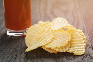 salted potato ships on old wooden table