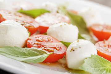 caprese salad with mini mozzarella balls and tomatoes