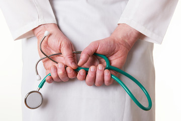 Close Up Of Doctor Holding Stethoscope Behind Back