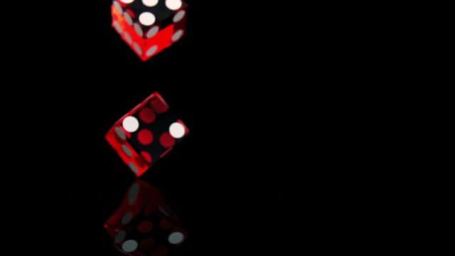Dice bouncing on black surface shooting with high speed camera, phantom flex.