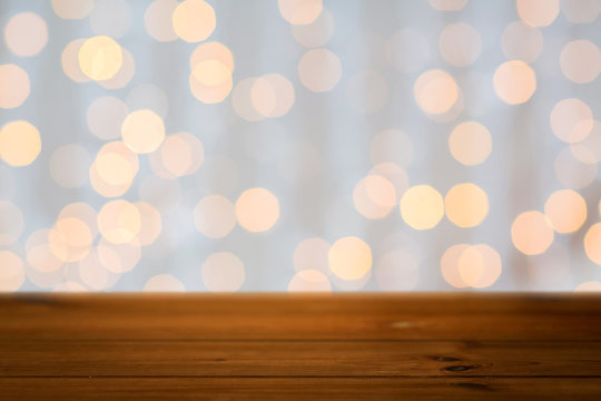 empty wooden table with christmas golden lights