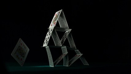 Pyramid house of playing cards falling down shooting with high speed camera, phantom flex. - Powered by Adobe