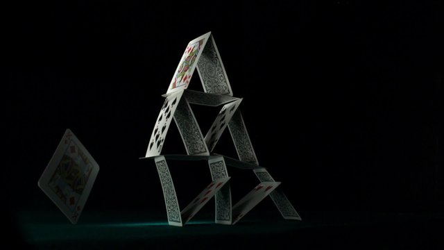 Pyramid house of playing cards falling down shooting with high speed camera, phantom flex.