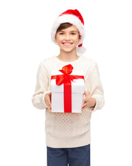 smiling happy boy in santa hat with gift box