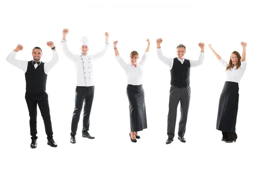 Happy Restaurant Staff Standing With Arms Raised