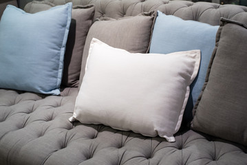 white pillow on grey sofa