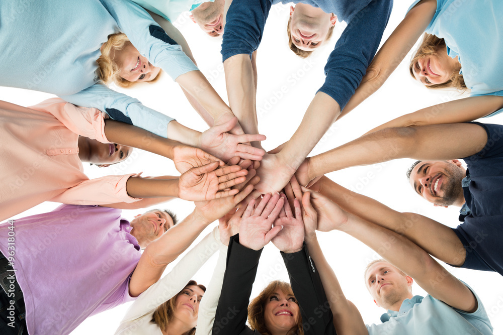 Wall mural creative business team stacking hands in huddle