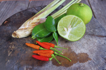 Lemongrass , Kaffir lime and lemon placed on the chopping block
