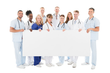 Confident Multiethnic Medical Team Holding Blank Billboard