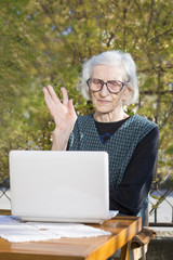 Senior woman having a video call on a notebook computer