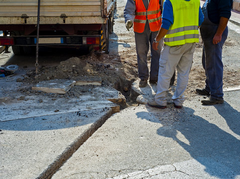 Workers during the construction of the broadband network with fiber glass in a city street