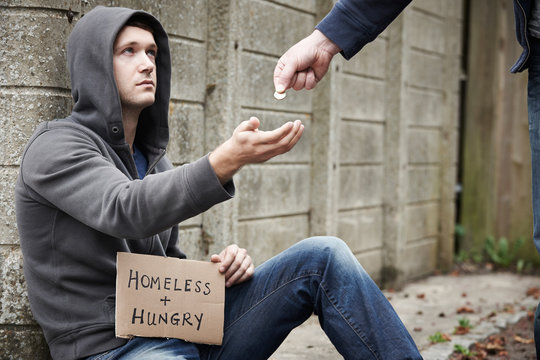 Man Giving Money To Beggar On Street