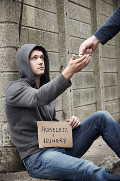 Man Giving Money To Beggar On Street