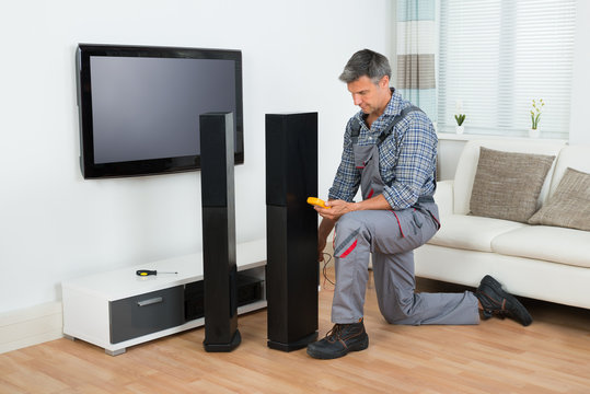 Technician Checking TV Speaker With Multimeter