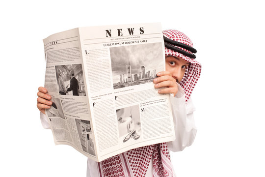 Sacred young Arab hiding behind a newspaper