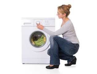 Woman Crouching While Using Washing Machine