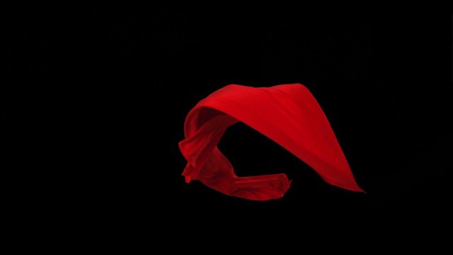 Red fabric flowing in the air on black background shooting with high speed camera, phantom flex.