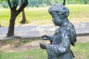 Fototapeta premium Children statue at Vachirabenjatas Park (Rot Fai Park).
