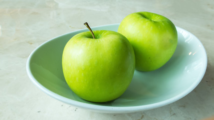 Two Green Apple with Shadow on White Bowl