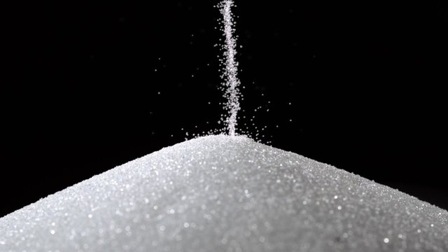 Pile of sugar on black background shooting with high speed camera, phantom flex.