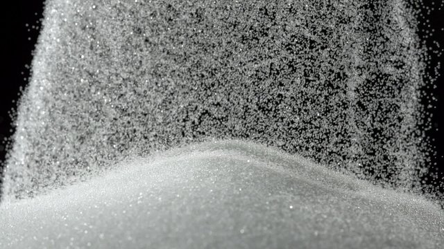 Pile of sugar on black background shooting with high speed camera, phantom flex.