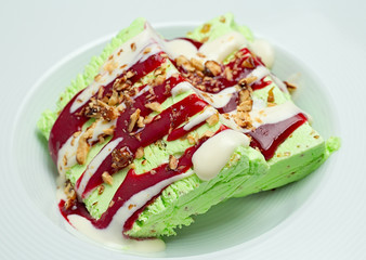 Two peaces of green deliciouse ice-cream on white plate closeup