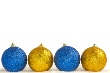 Christmas decorations on a white background. Four balls on artificial snow