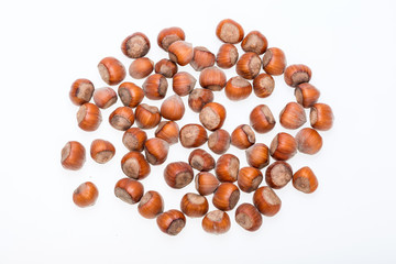 Pile of hazelnuts isolated on white background