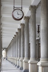 Old clock, and stone columns in Karlovy Vary, Czech Republic