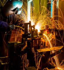 MIG welder uses torch to make sparks during manufacture of metal equipment.