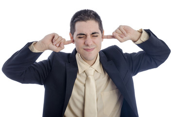 Man in business suit covering his ears with his finger.