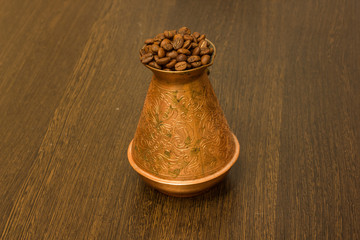 Copper cezve for coffee with coffee beans