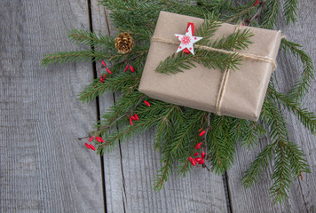 New year gift box handicraft wrapping, parchment, twine fir tree twigs, cute simple last minute present handmade. Top view.