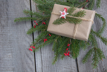 Christmas gift box handicraft wrapping, parchment, twine fir tree twigs, cute simple last minute present handmade. Top view.