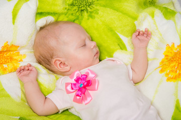 The two-month baby carefree sleeping on the bed
