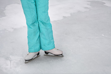 Young girl skating on the frozen lake