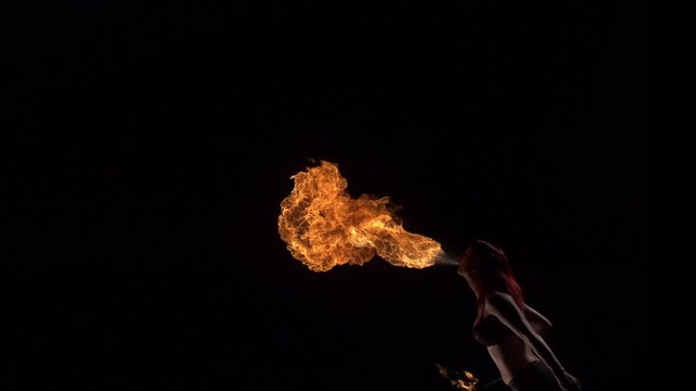 Fire performer blowing fire shooting with high speed camera, phantom flex.