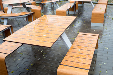 Wet outdoor cafe tables on the street