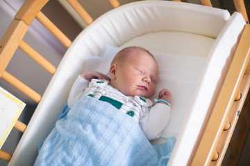 Newborn baby boy in hosptal cot