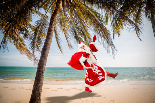Santa Claus with a gifts on the beach