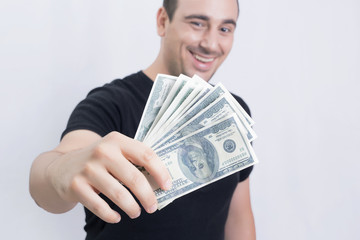 Smiling man showing dollar bills