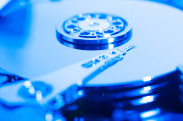 Inside hard drive cylinder and head macro blue color