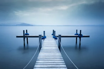 Washable wall murals Pier Lake Zug. Wooden pier on the lake. Fog. Long exposure. 
