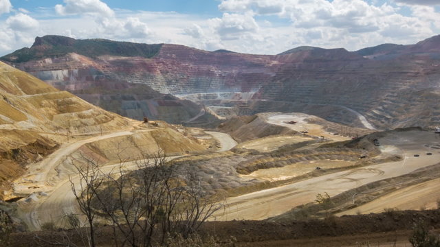 Wide angle camera pan across open pit copper mine in New Mexico, USA