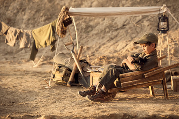 Boy playing with a puppy archaeologist at the dig