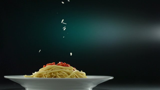 Putting parmesan chese on spaghetti shooting with high speed camera, phantom flex.