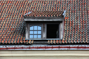 Windows in attic of old tiled roof.