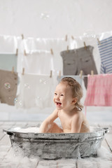 Bathing baby in the laundry room 