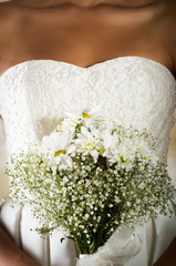 Closeup shot of bridal flower bouquet held by a bride
